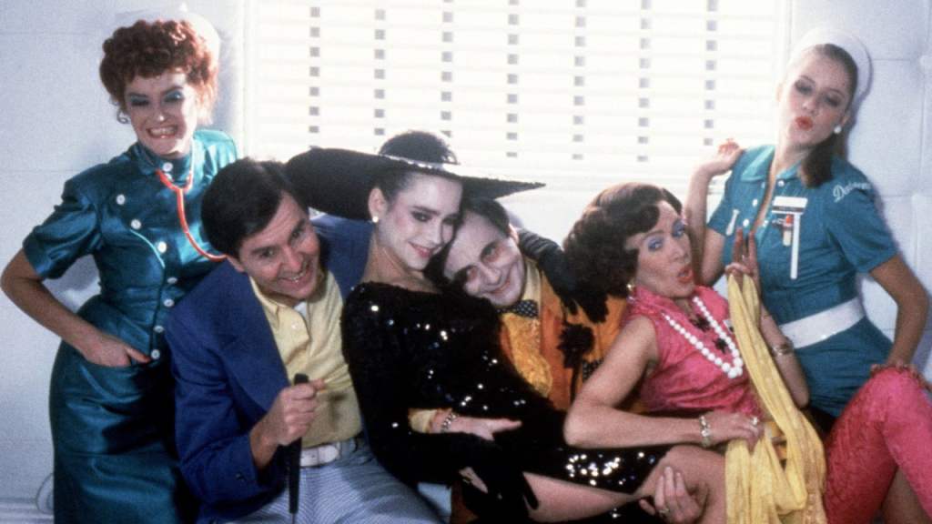The ensemble cast of Shock Treatment pose around Janet, who has become a star through sinister happenings
